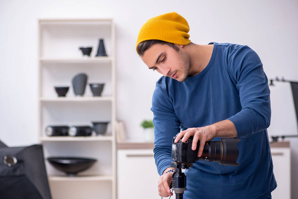 Young male photographer working in the studio - Photo, Image
