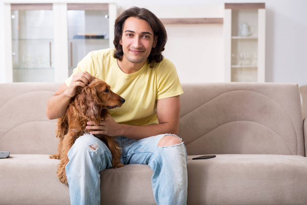 Young man with cocker spaniel dog - Photo, Image