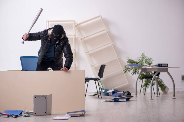 Young male burglar in the office - Foto, Imagen