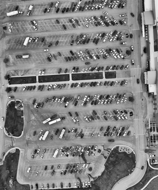 Aerial view of cars at large outdoor parking lots, USA. Outlet mall parking congestion and crowded parking lot, other cars try getting in and out, finding parking space. - Photo, Image