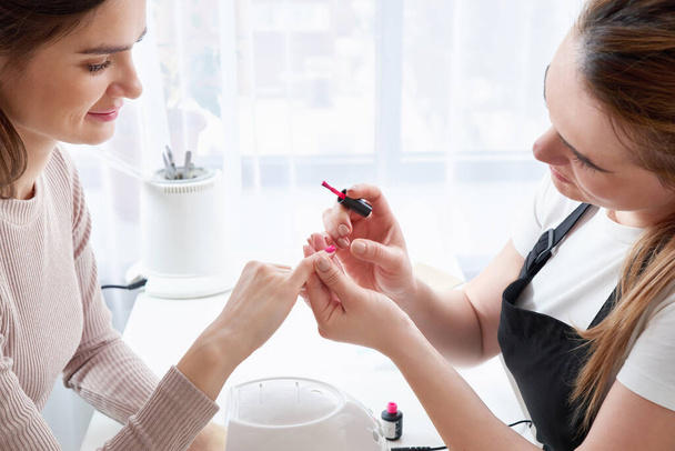 Woman getting a manicure at the nail salon - Фото, зображення