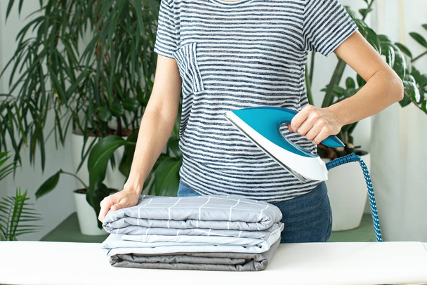 ironing of clothes. Homework. responsibilities for maintaining the house. Steam steamer. - Valokuva, kuva