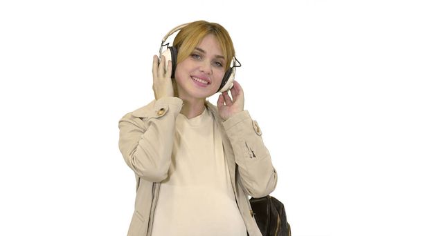 Young attractive pregnant woman listening to music in headphones - Foto, Bild