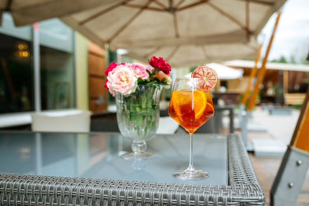 Glass of aperole spritz cocktail on with flowers - Photo, Image