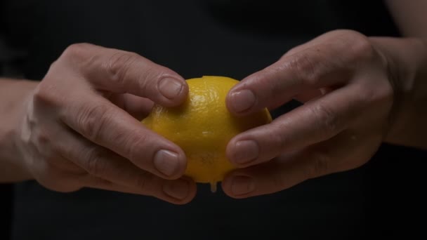 Professional chef squeezes lemon fruit slowly. Close up. - Footage, Video
