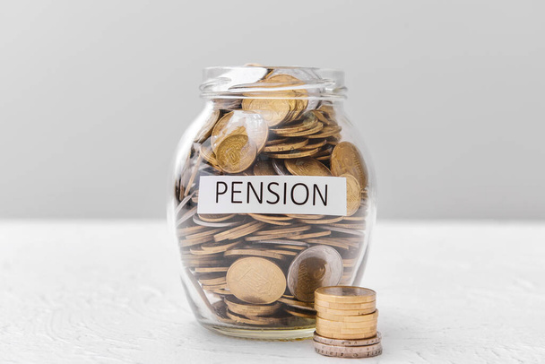 Jar with savings on table. Concept of pension - Photo, Image