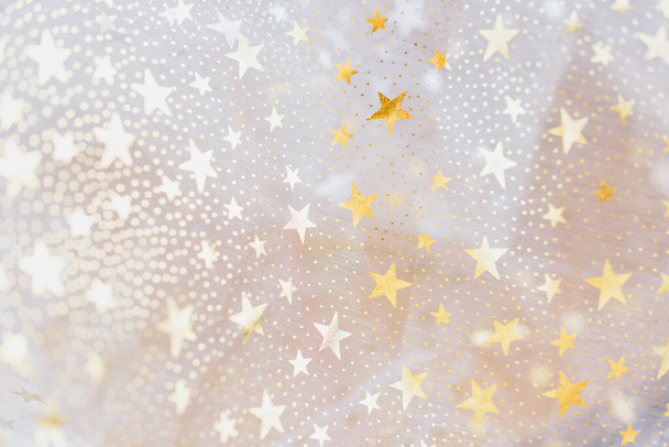 gold glitter and glittering stars on white festive background. Winter holidays background. Christmas and Happy New Year greeting card. Wedding. Birthday. selective focus - Foto, Imagen