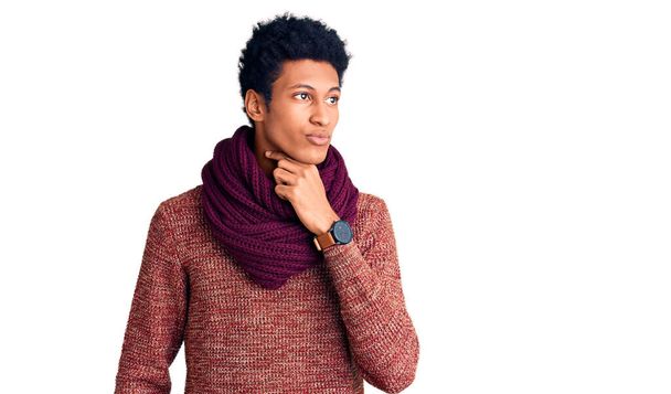 Young african american man wearing casual winter sweater and scarf touching painful neck, sore throat for flu, clod and infection  - Photo, Image