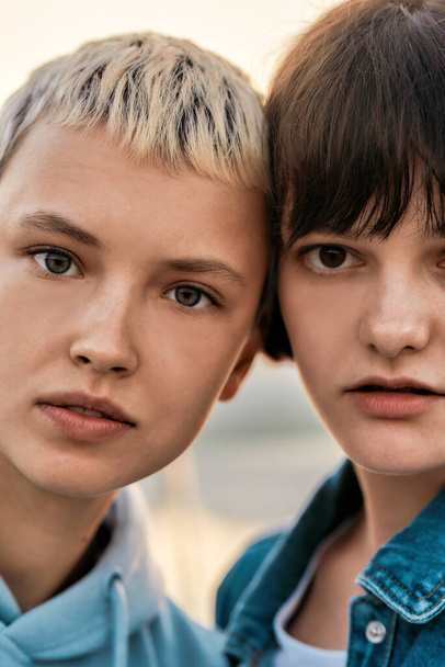 Close up portrait of two attractive young women with short hair looking at camera, Young lesbian couple spending time together - Φωτογραφία, εικόνα