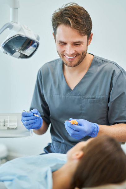 Male dentist and woman in dentist office - Photo, Image