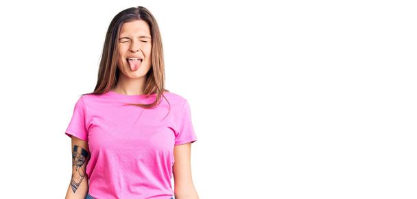 Beautiful caucasian woman wearing casual clothes sticking tongue out happy with funny expression. emotion concept.  - Photo, Image