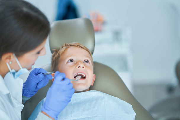 Μικρό αγόρι και γυναίκα οδοντίατρος στο οδοντιατρείο - Φωτογραφία, εικόνα