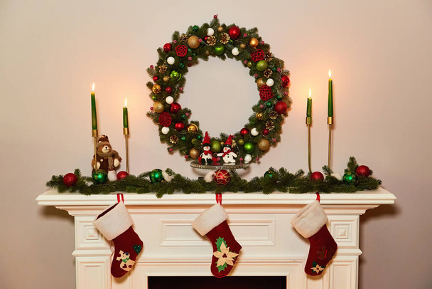 Christmas wreath above classical fireplace. Xmas scene. Place for text. Suitable for Christmas background. - Foto, Imagem