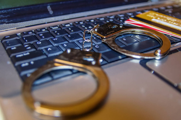 handcuffs, card on a laptop - Photo, Image