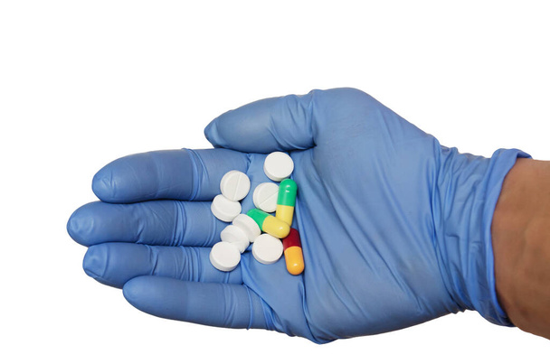 the pills in hands in blue gloves - Фото, зображення