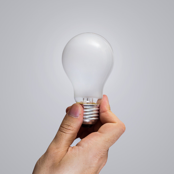 Hand with light bulb - Foto, Imagen