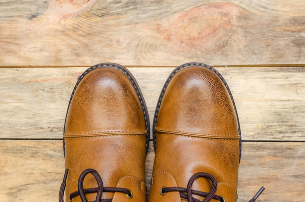 Rounded nose of men's brown shoes on a wooden background close-up with a copy of the space. view top - Foto, Bild