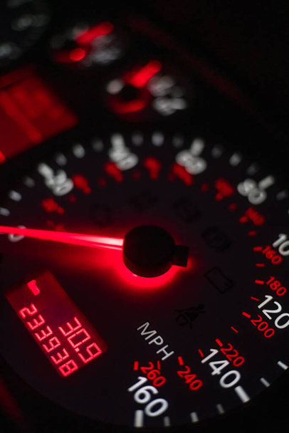 car dashboard. Speedometer with red backlight at night close up. Vertical photo - Photo, Image