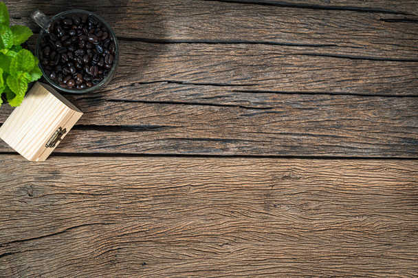 cup of coffee beans and a wooden box on the table top view - 写真・画像