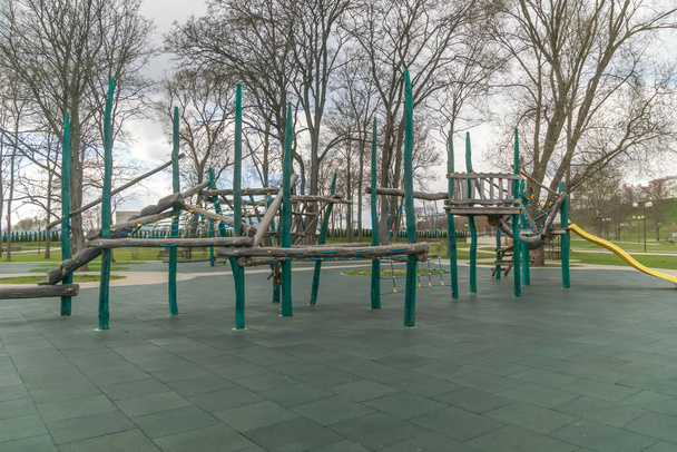 Outdoor sports ground. Ppassage of the wall obstacles. Children's play complex on an open sports field in early spring - Photo, Image