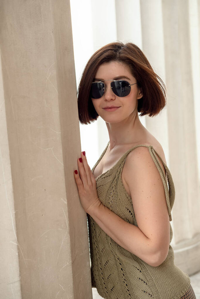 Outdoor fashion portrait of a  young woman with sun glasses. Photo of beautiful stylish brunette woman in the city. Fashion fall autumn spring photo - Fotoğraf, Görsel