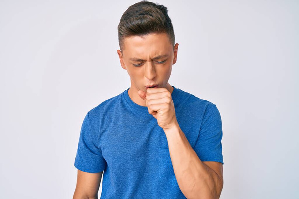 Young hispanic boy wearing casual clothes feeling unwell and coughing as symptom for cold or bronchitis. health care concept.  - Photo, Image