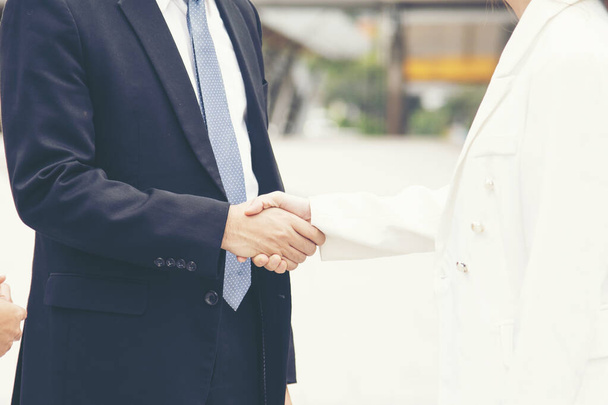 Congratulation to collaboration partner after sign on contract. Diverse Businessman shake hands together with businessman to introduce meeting. Trustworthy student friends meeting. Business Concept - Photo, Image