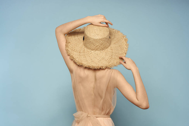Woman in hat with naked back on blue background model back view - Фото, зображення