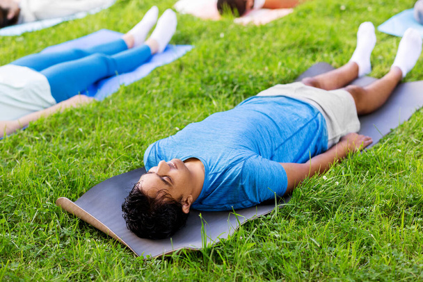 group of people doing yoga at summer park - Fotoğraf, Görsel