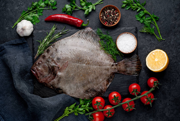 raw flounder fish with spices on a stone background - Фото, изображение