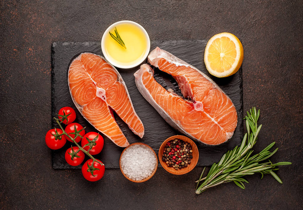 Raw fish salmon steaks with ingredients on a stone background - Photo, Image