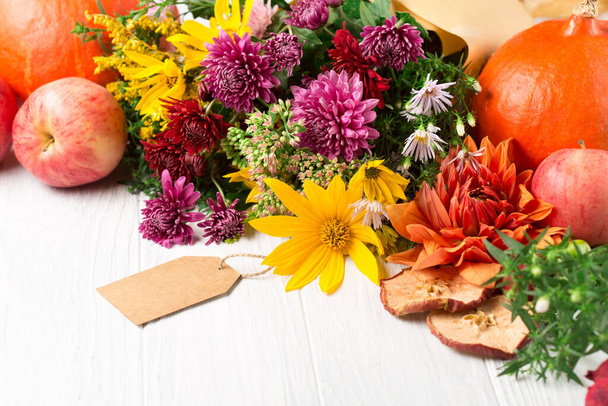 Autumn bouquet of yellow and pink flowers on white wooden background. Autumn concept for Thanksgiving day or for other holidays.  Selective focus, copy space.  - Photo, Image