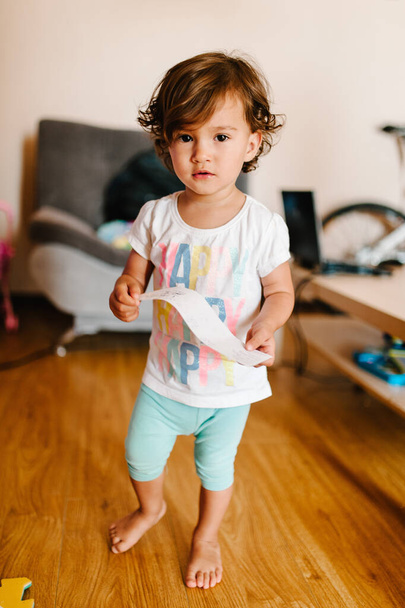 Portrait of a pretty, cute, toddler, girl, adorable baby playing toys indoors, little child play game having fun moving on the floor in a room at home or kindergarten. - Fotó, kép