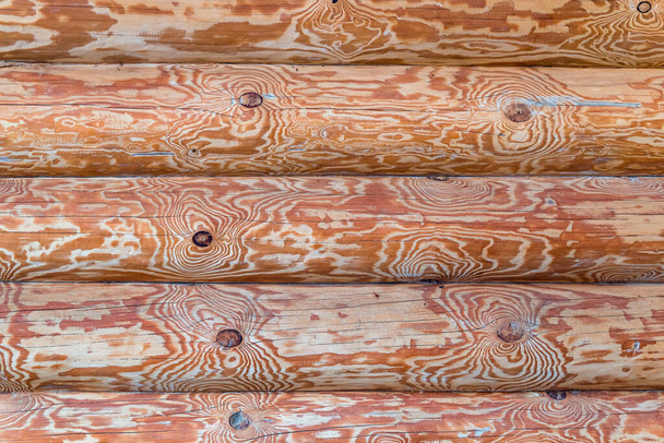 Wall of logs of a wooden house - abstract architecture background - Foto, imagen