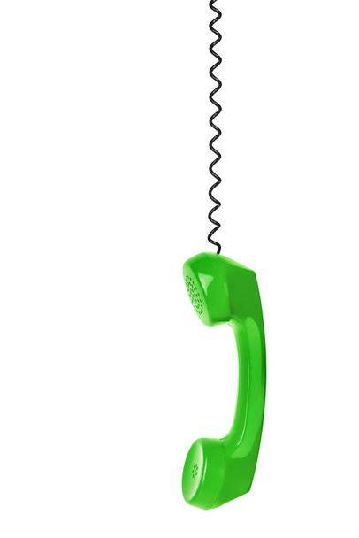 Green phone and cable isolated on white background - 写真・画像