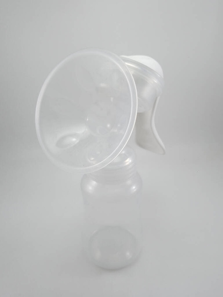 Clear plastic silicone breast pump use for lactating mother - Photo, Image