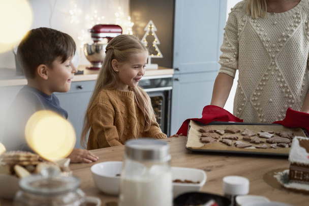 Children happy because of hot gingerbread cookies - Photo, Image