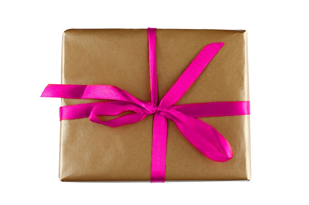 Arkaplanda pembe fiyonklu kahverengi hediye paketi - Fotoğraf, Görsel