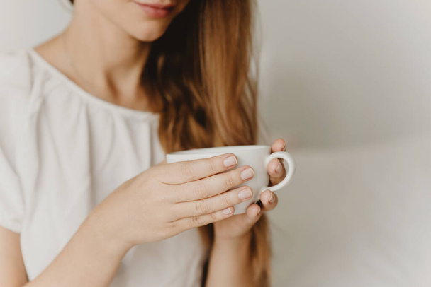 Cropped view of woman holding cup of coffee or tea closeup. - Foto, afbeelding