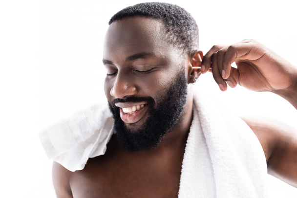 portrait of afro-american man cleaning ears with pleasure - Photo, Image