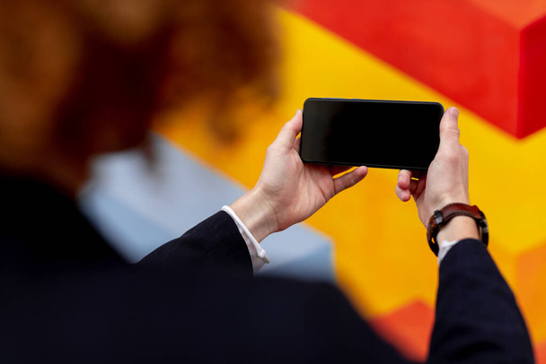 Unrecognizable guy using smartphone with black screen - Foto, afbeelding