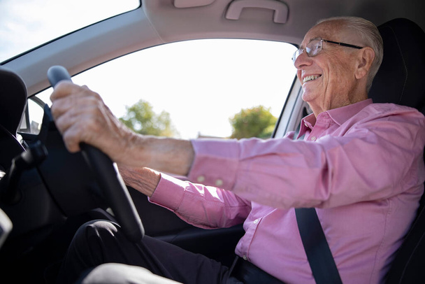 Smiling Senior Man Enjoying Driving Car - Photo, Image