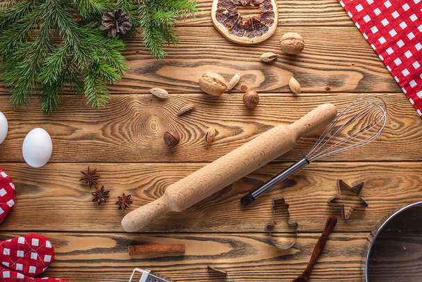 Ingredients and kitchen accessories for cooking festive homemade pastry. Concept of a cozy festive mood and preparation for Christmas. - Fotoğraf, Görsel