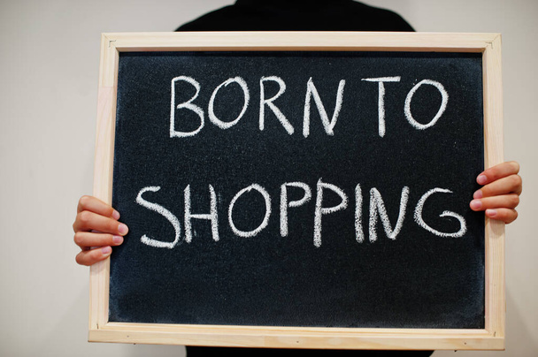 Born to shopping written on blackboard. Black friday concept. Boy hold board. - Photo, Image