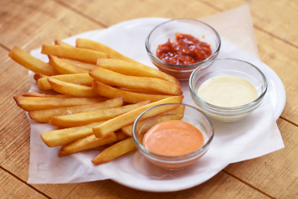 Tasty french fries on wooden table background - Photo, Image