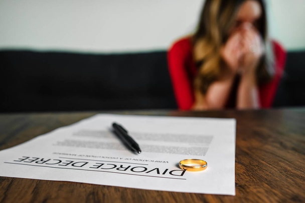 Divorce decree document. Woman is crying on the background. - Zdjęcie, obraz