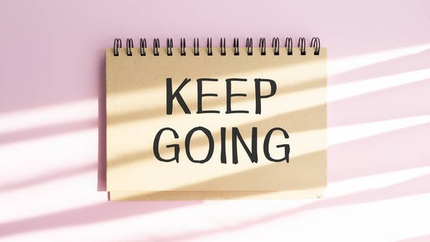 Handwriting Announcement text showing Keep Going. Business concept for Go Moving Forward Letting written on notebook with space on book background with marker pen - Fotografie, Obrázek