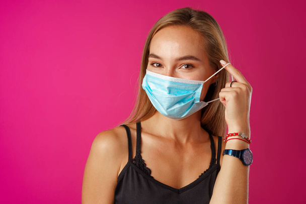 Young beautiful casual woman wearing protective medical mask - Foto, afbeelding