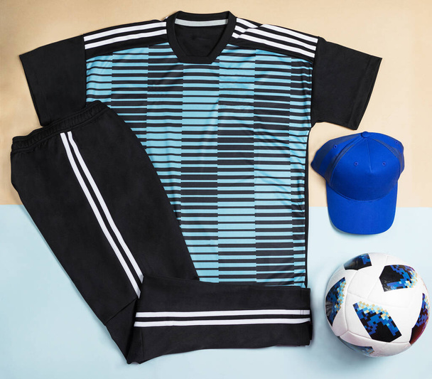 Blue soccer t-shirt design slim-fitting with a cap an ball top view - Fotoğraf, Görsel