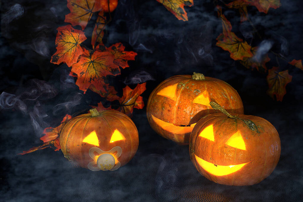 Halloween pumpkins with glowing eyes with smoke and fog. - Fotoğraf, Görsel